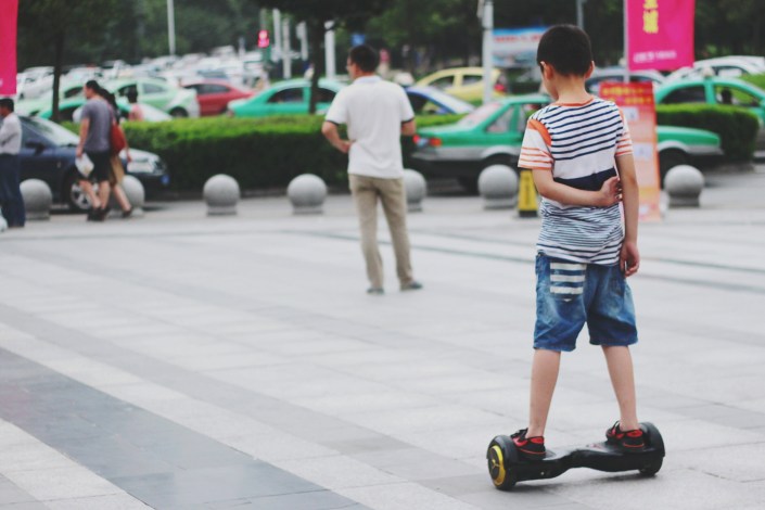 Boy In Segway On Street